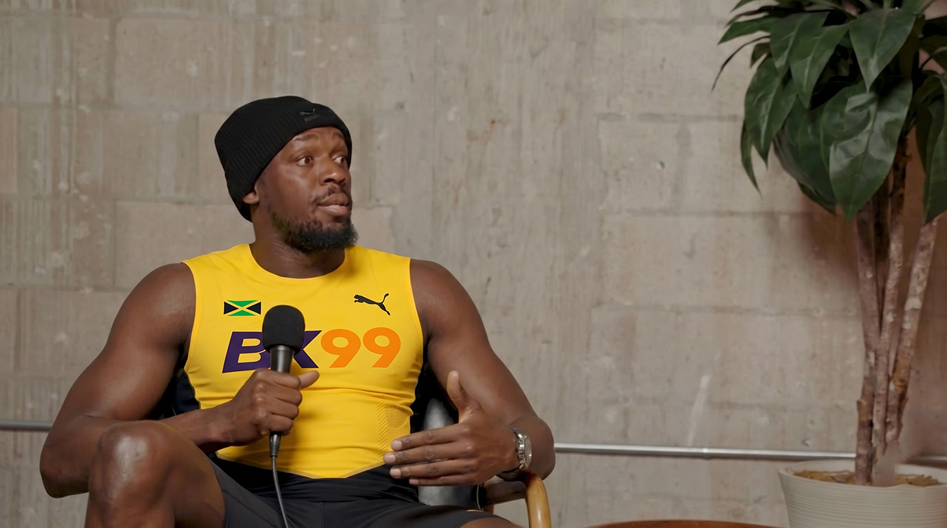Phil Jones sitting in a leather chair wearing an official ACE66 jersey, talking to the camera and holding an ACE66 script